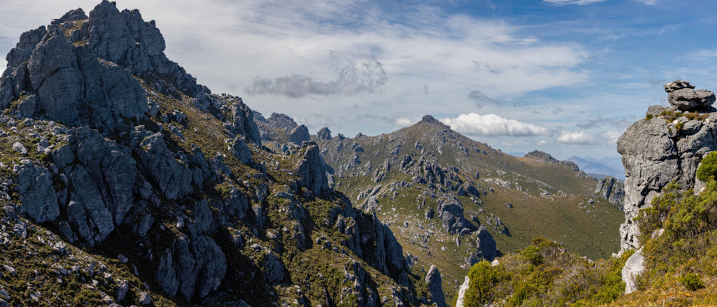 This spectacular panorama cannot do justice to the scale and grandeur of this landscape. The peaks in the center distance are 4km away! The mountain to the left rises 800m above the valley floor below. I was overwhelmed. Taken from atop the Western Arthurs in Tasmania, Australia.