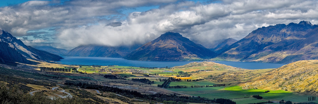 A panorama of tumultuous clouds rolling off the Remarkables onto Lake Wakatipu near Queenstown on the South island of New Zealand.